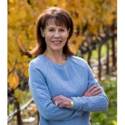 She is posing with her hands folded.